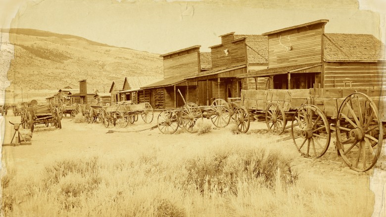 an Old West town with wagons in front of store fronts
