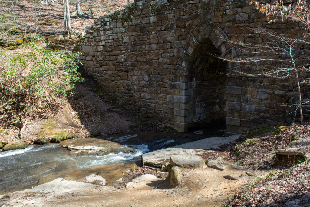 View of the base of an old stone bridge