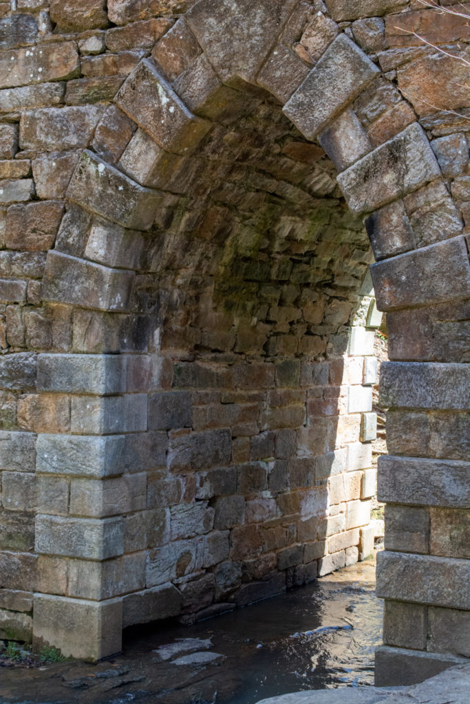 View of the underside of an old stone bridge