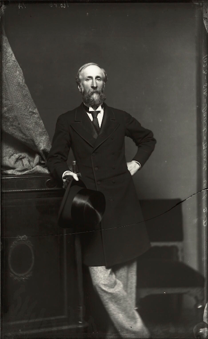 An elderly Victorian man standing