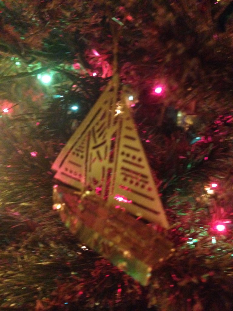 A brass sailboat ornament