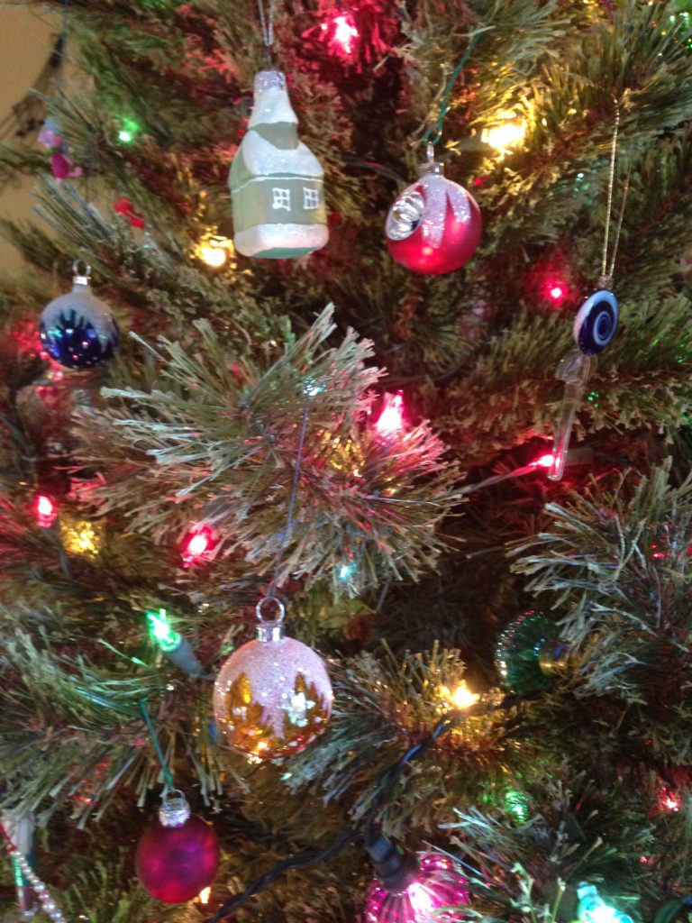 A close up of Christmas ornaments on a tree